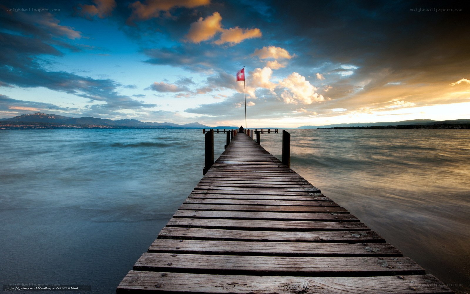 Pier at sunset with Swiss flag