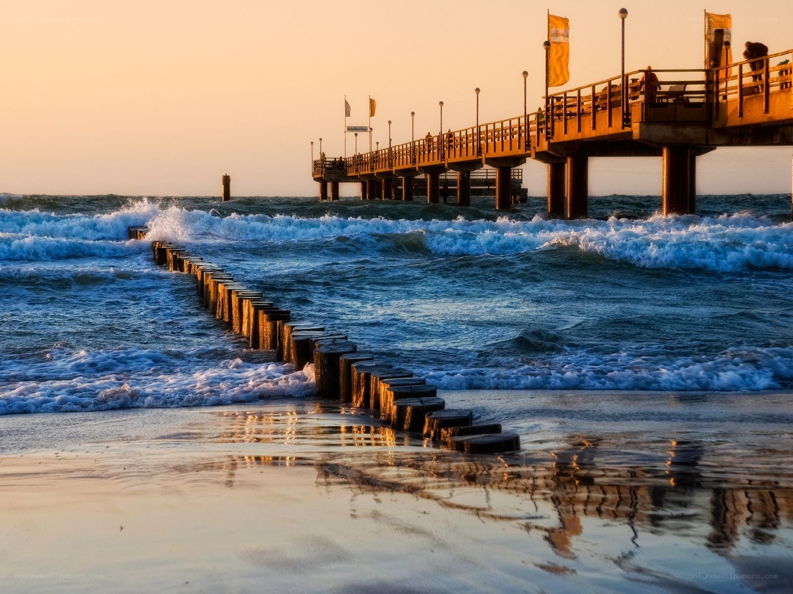 Pier at sunset with waves