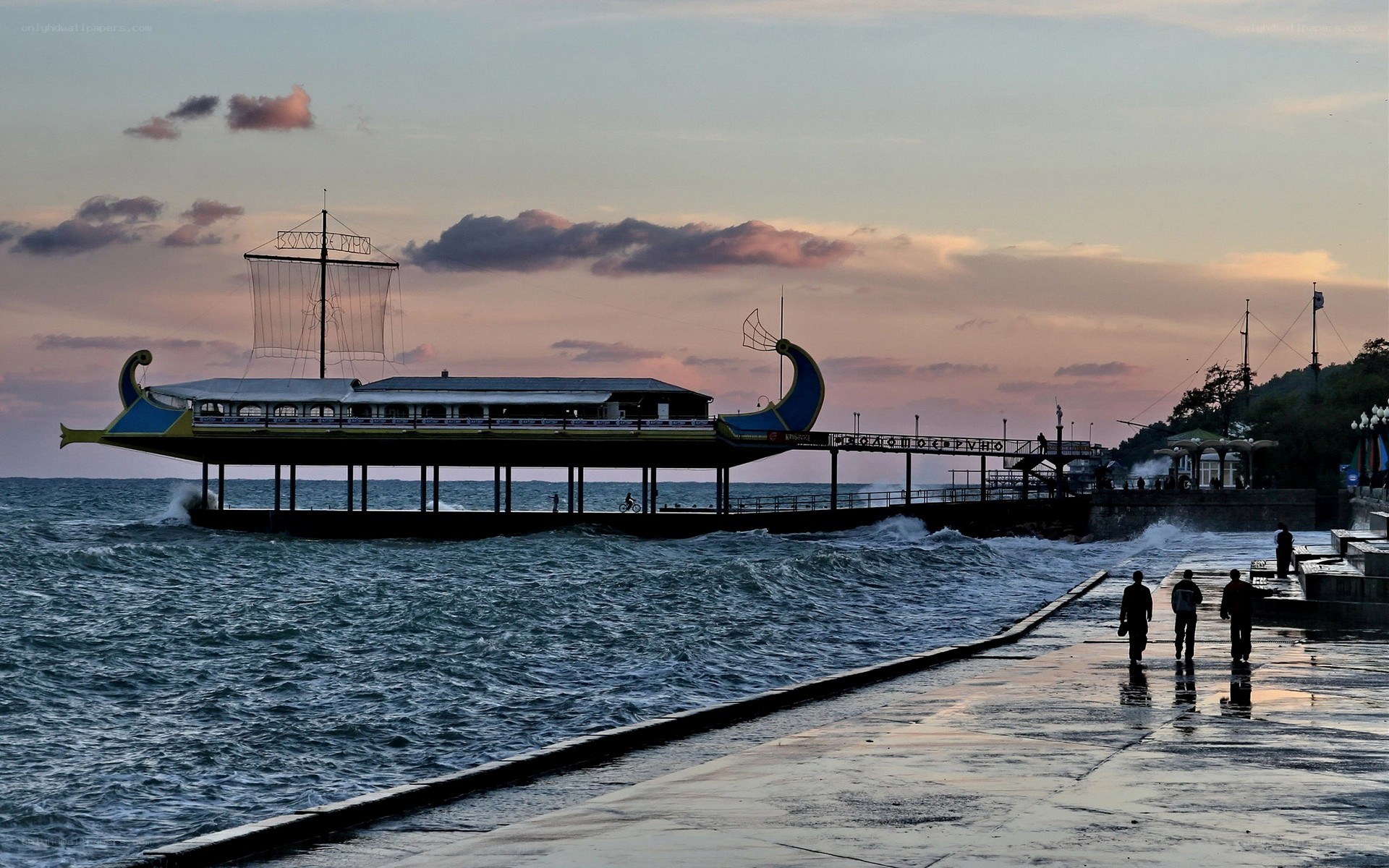 Pier at sunset with waves