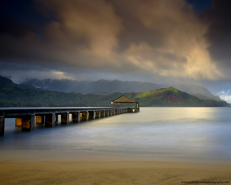 Pier at the beach with mountains