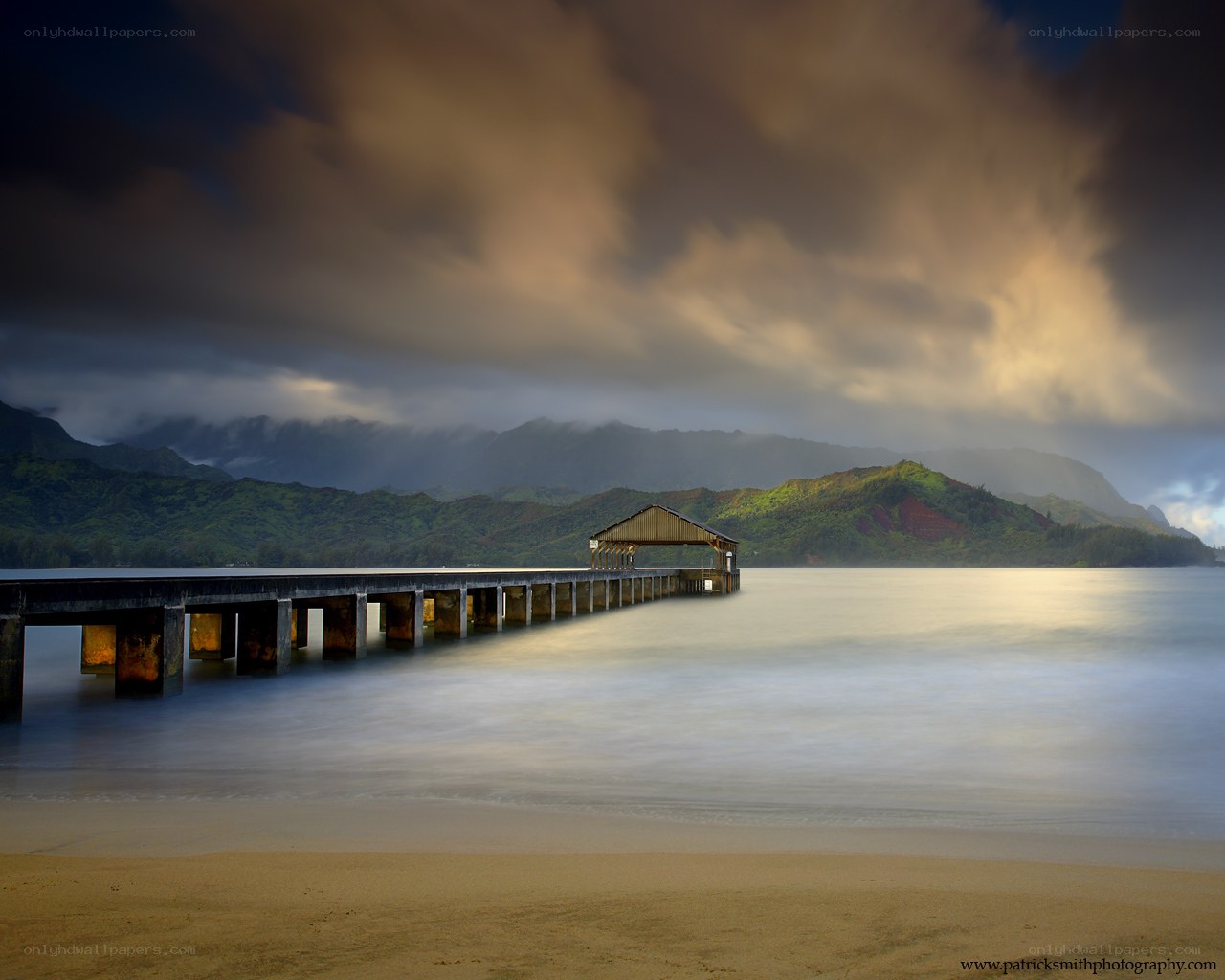 Pier at the beach with mountains