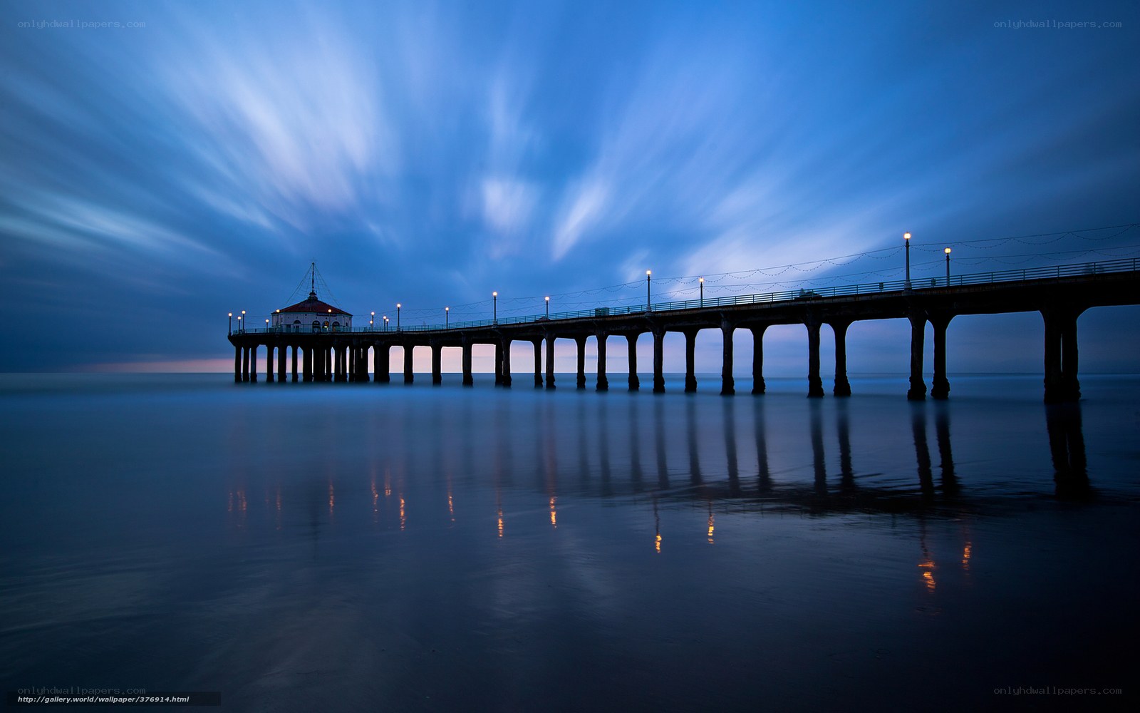 Pier at twilight with light trails