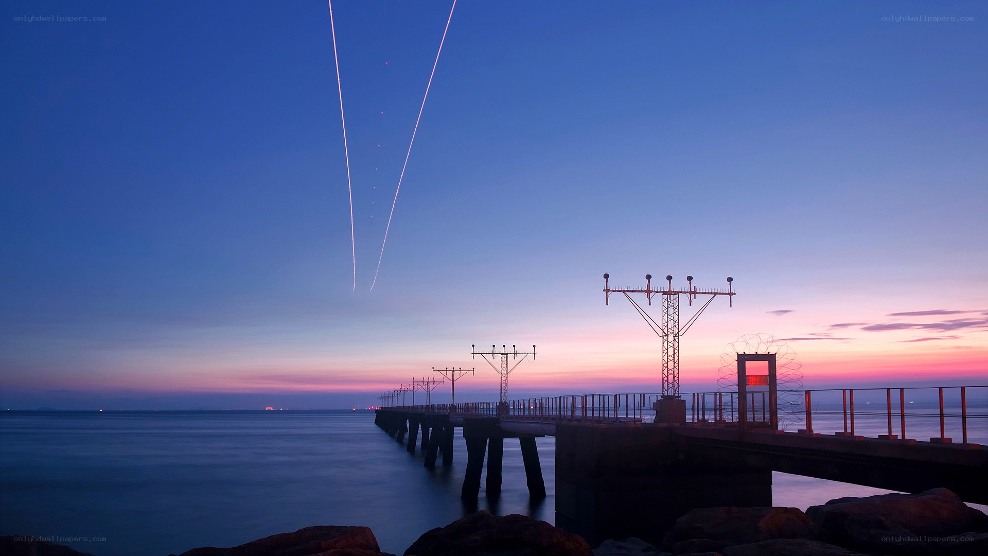 Pier at twilight with light trails