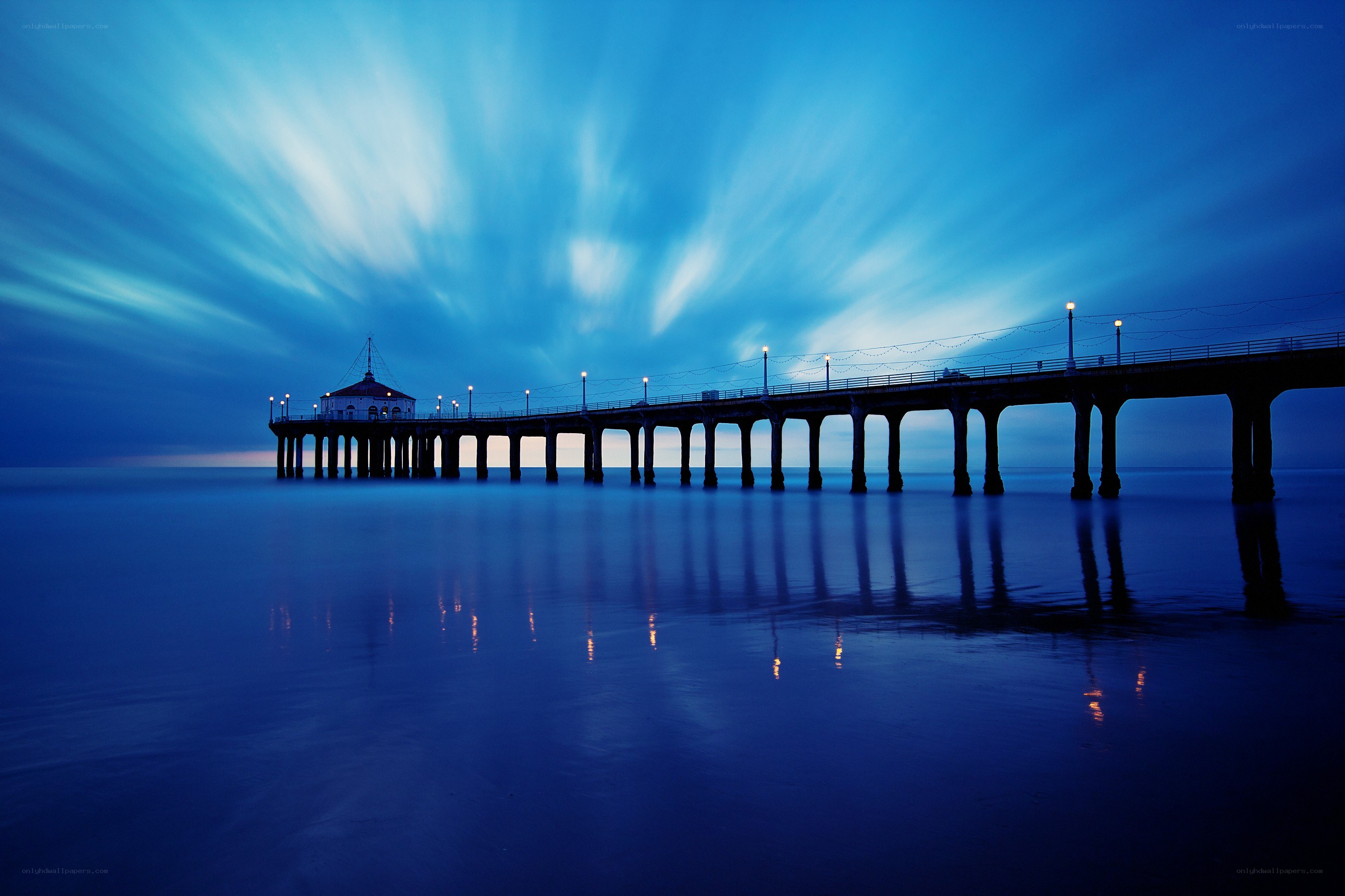 Pier at twilight with light trails