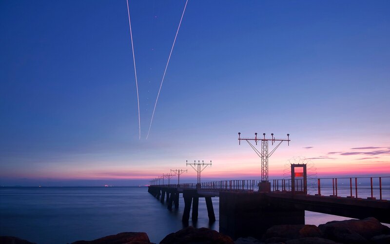 Pier at twilight with light trails