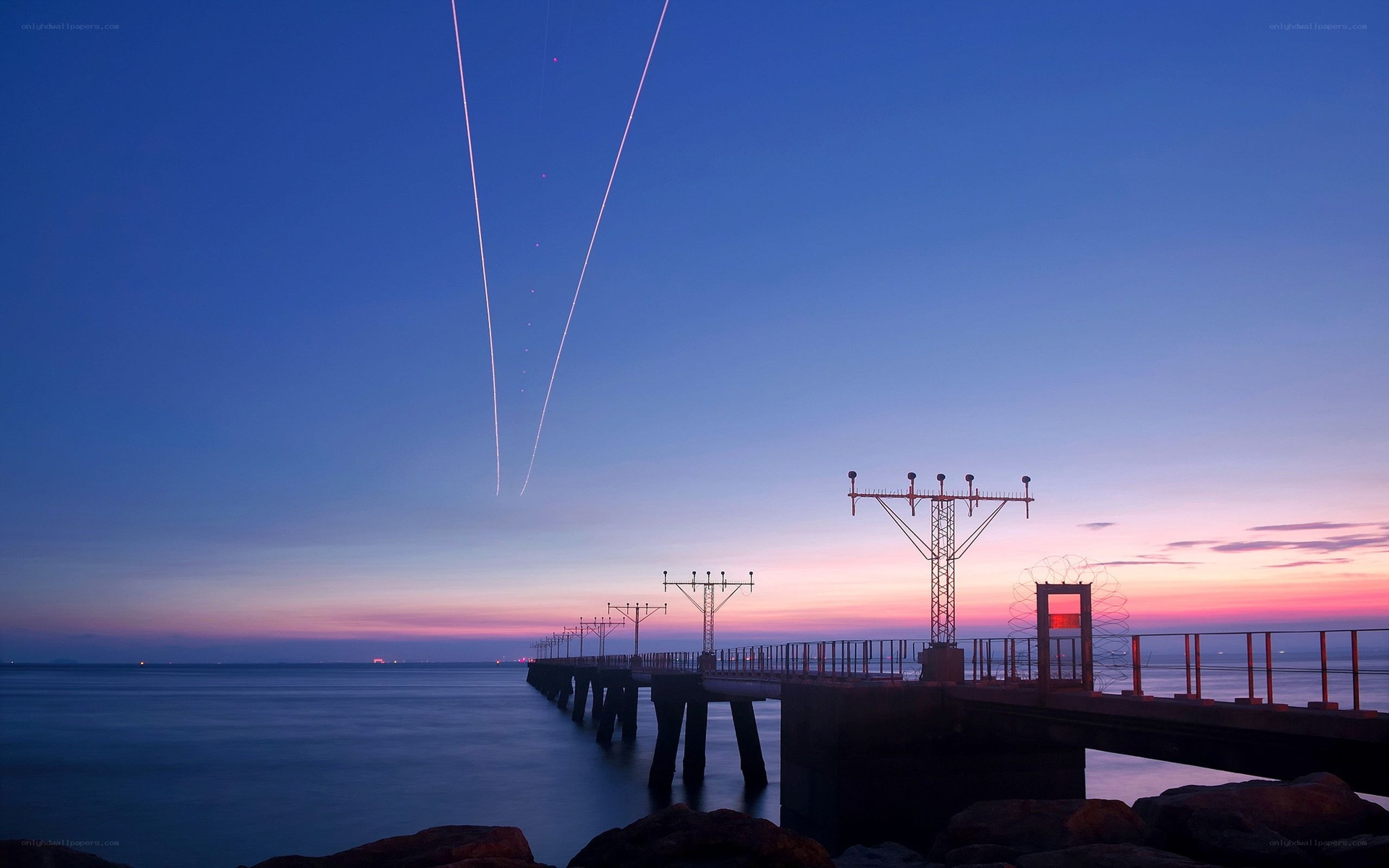 Pier at twilight with light trails