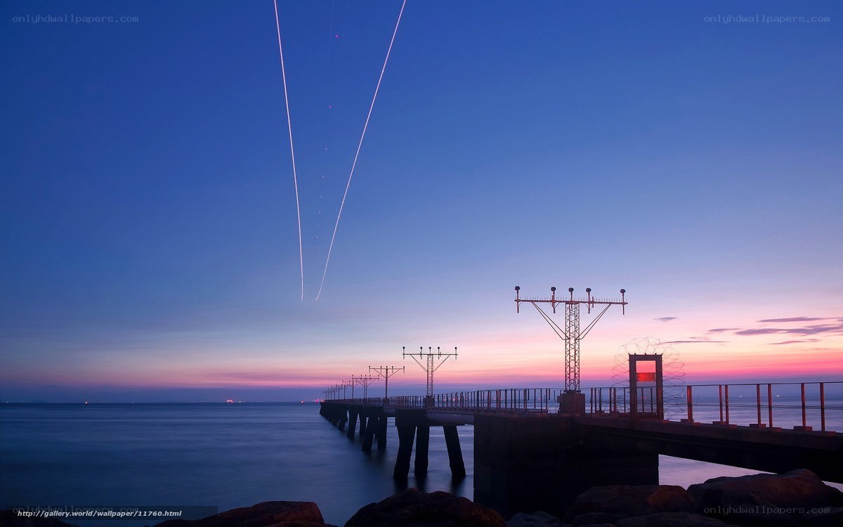 Pier at twilight with light trails