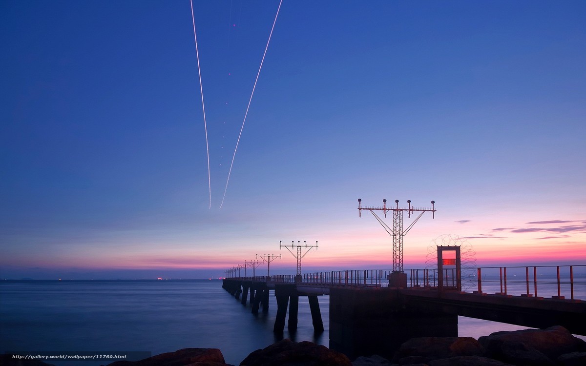 Pier at twilight with light trails