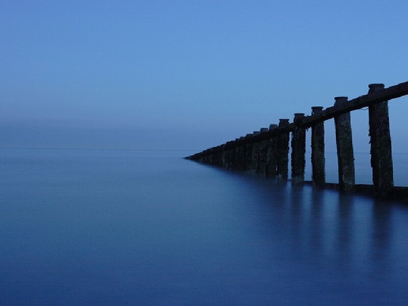 Pier extending into calm sea