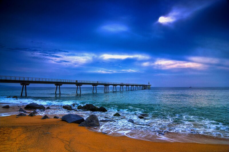 Pier Extending into Ocean — Blue, Dramatic, Night