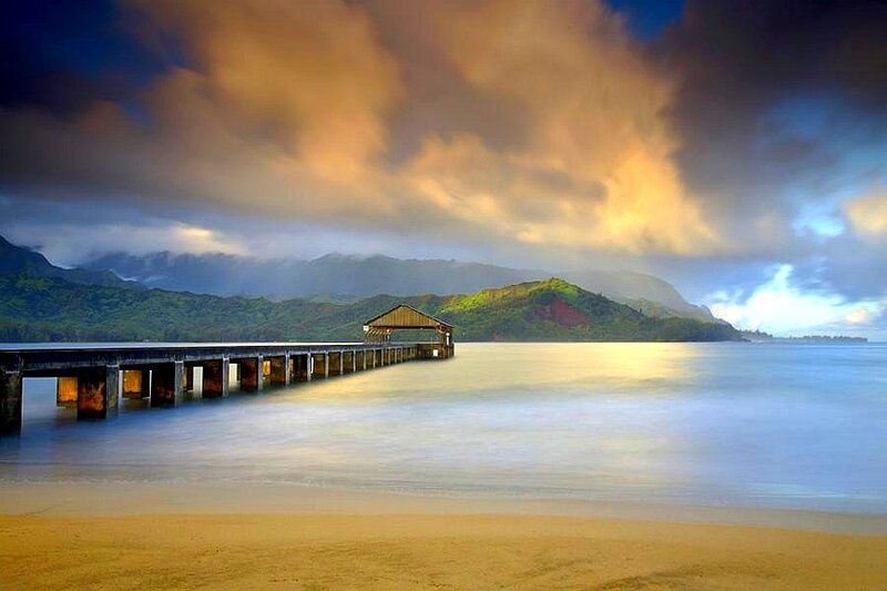 Pier Extending into Ocean — Blue, Dramatic, Sunset, Photograph, Mountains