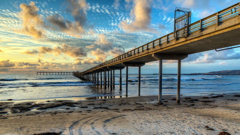 Pier Extending into Ocean — Blue, Dramatic, Sunset