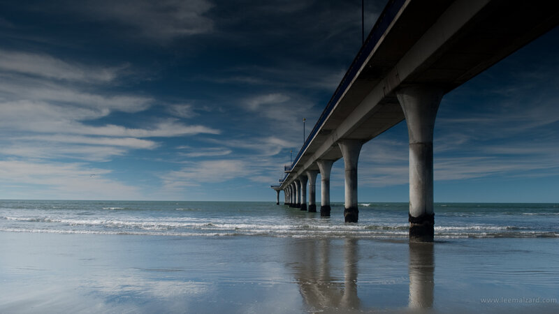 Pier Extending into Ocean — Blue, Dramatic