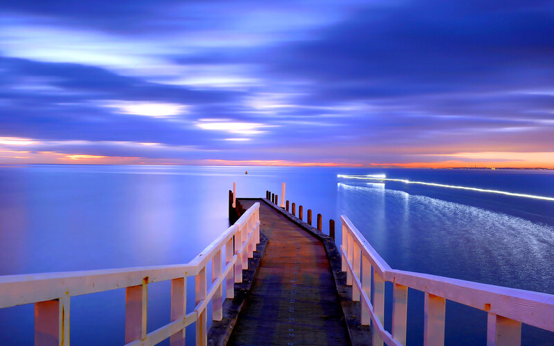 Pier Extending into Ocean — Blue, Serene, Sunset
