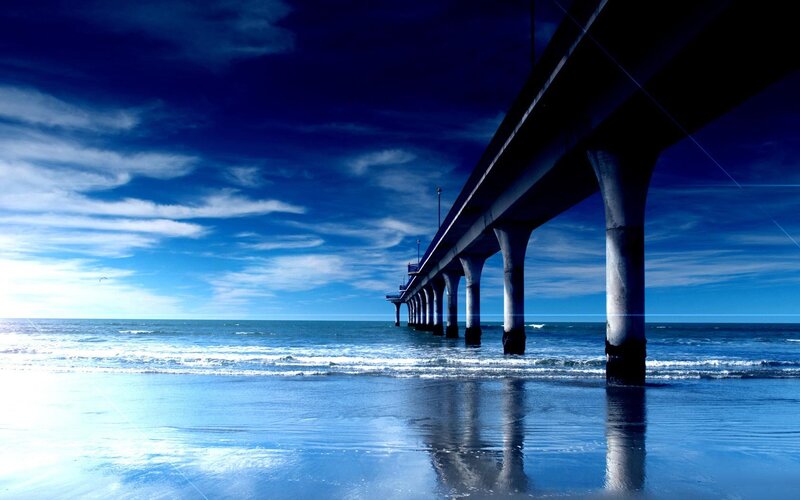 Pier Extending into Ocean — Blue