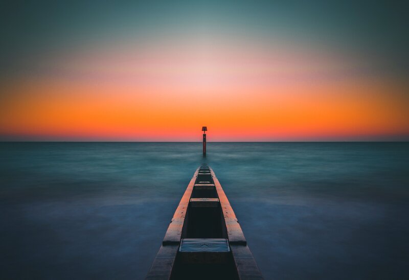 Pier Extending into Ocean — Orange, Serene