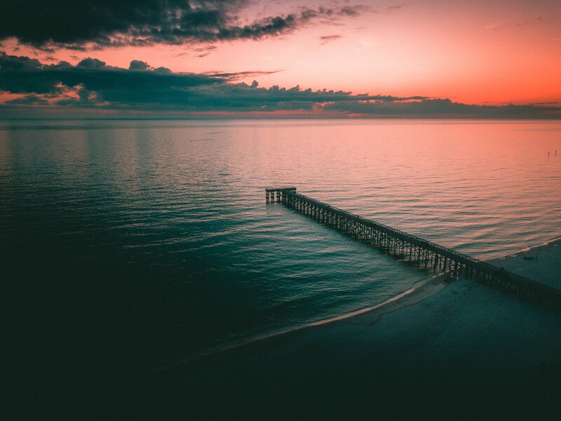 Pier Extending into Ocean — Pink
