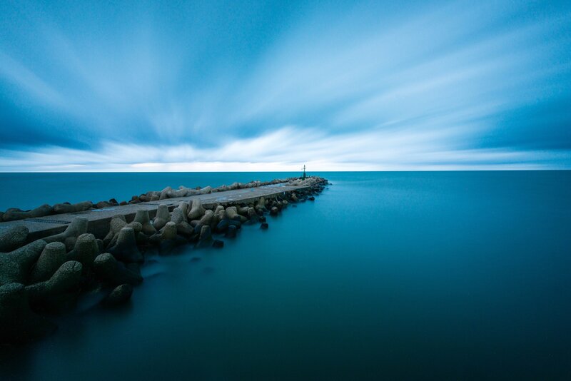 Pier Extending into Sea — Blue, Serene, Night