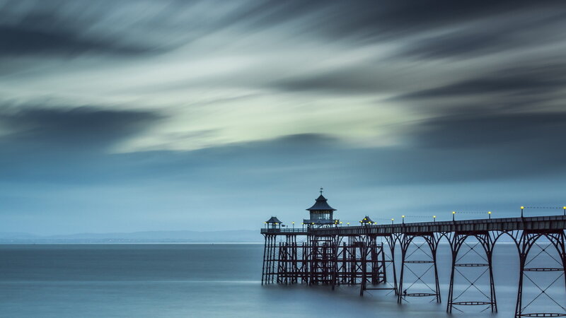 Pier Extending into Sea — Blue