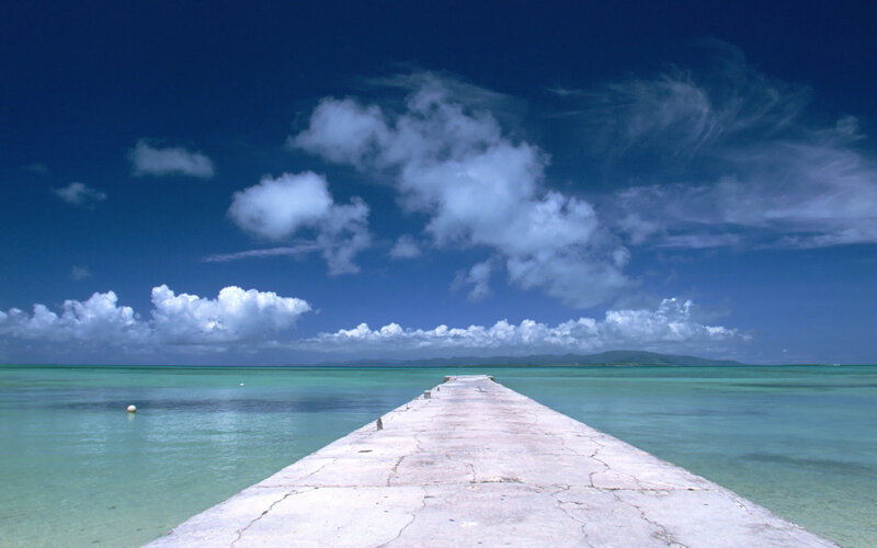 Pier extending into turquoise sea