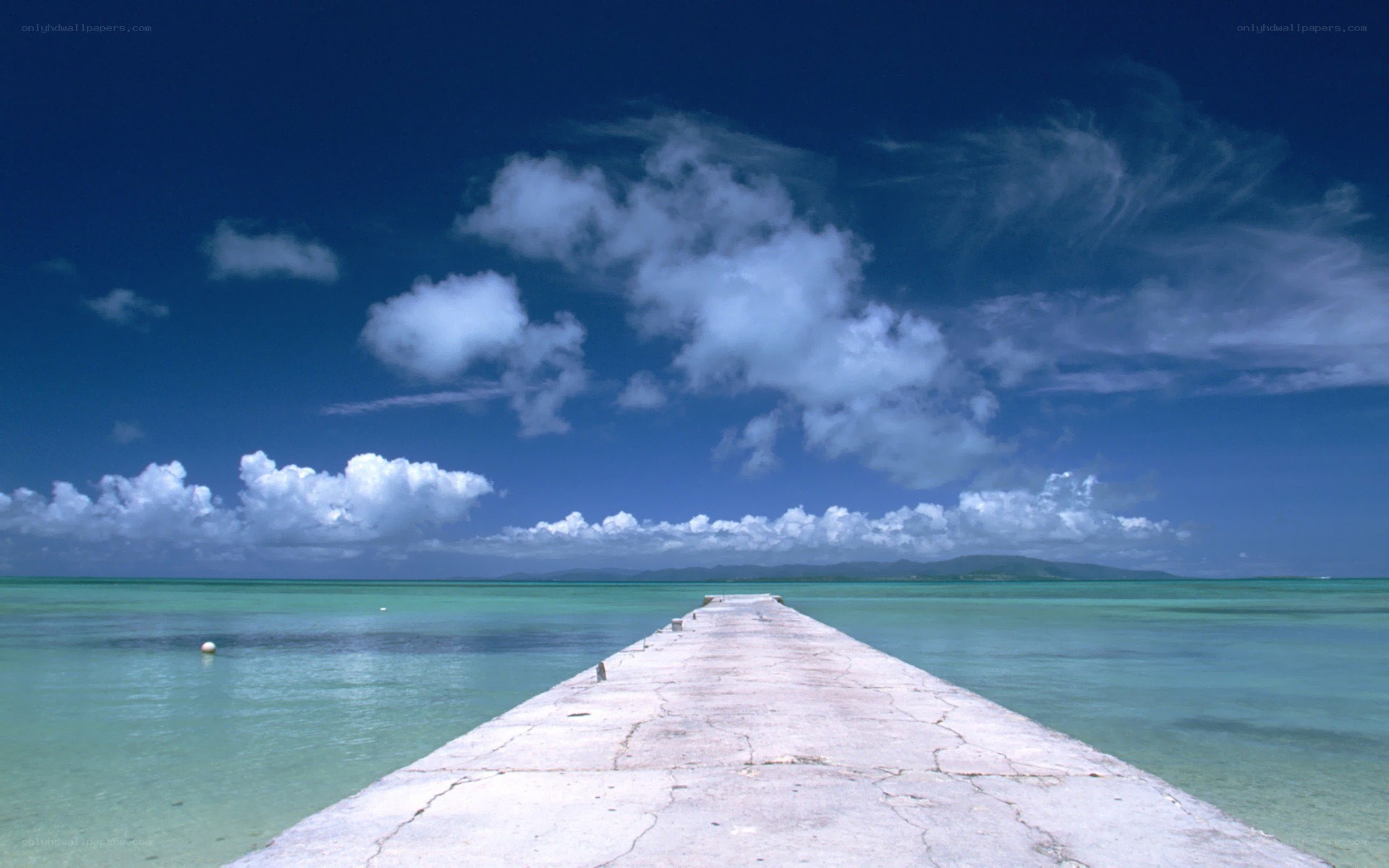 Pier extending into turquoise sea