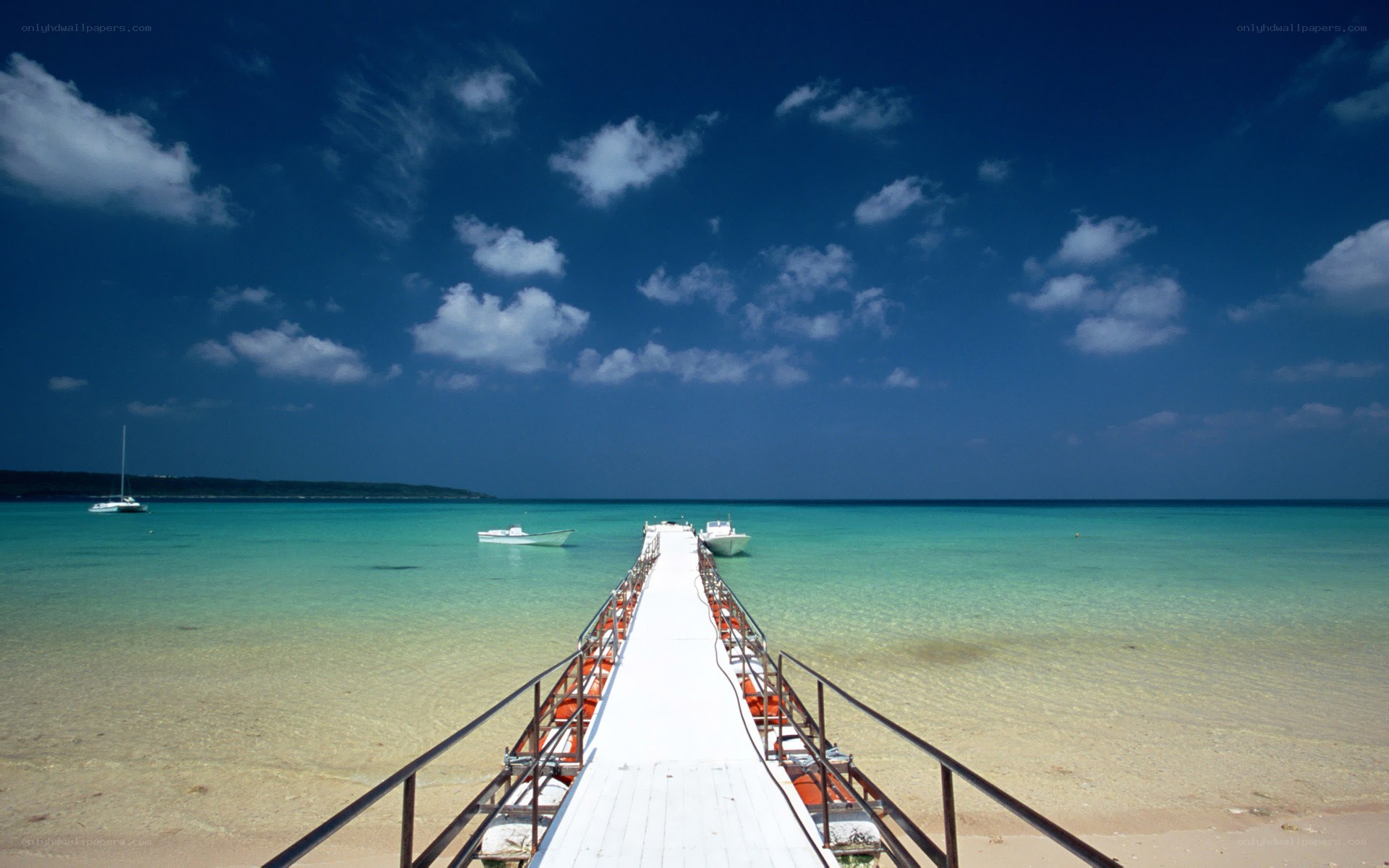 Pier extending into turquoise sea