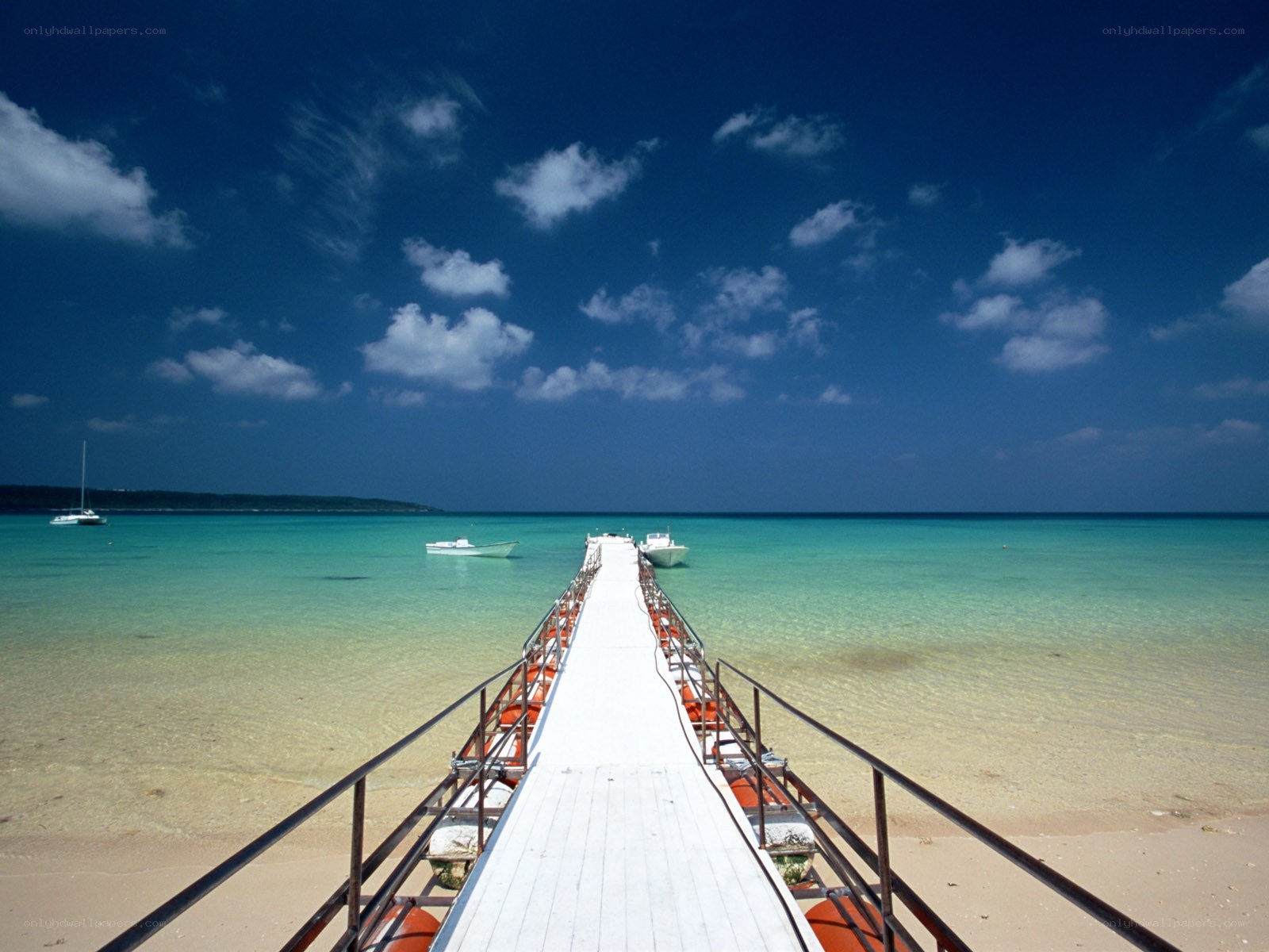 Pier extending into turquoise sea