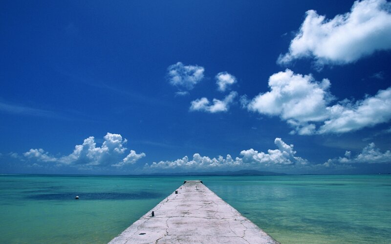 Pier extending into turquoise sea