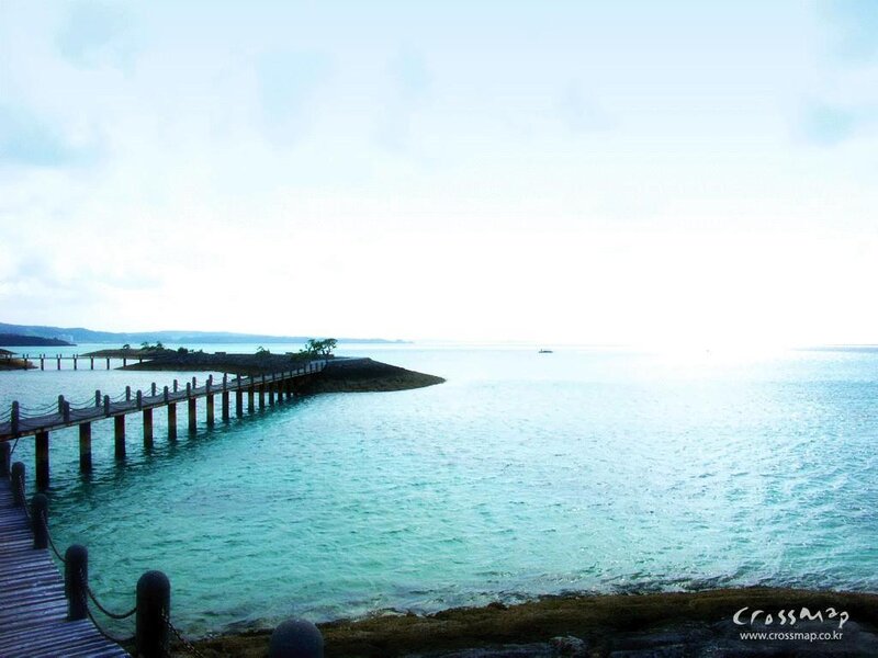 Pier extending into turquoise sea