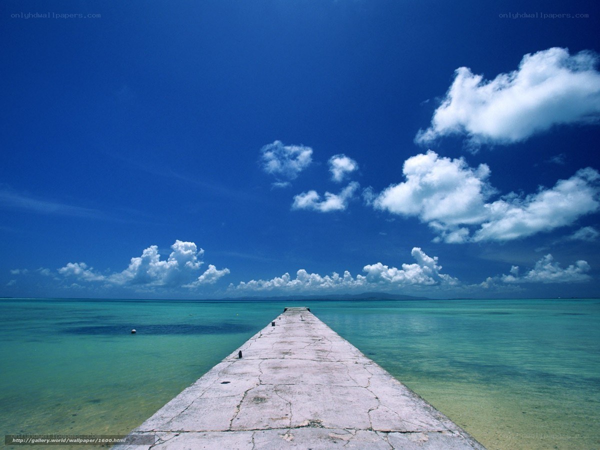 Pier extending into turquoise sea