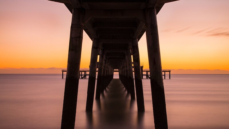 Pier Pillars at Sunset — Orange