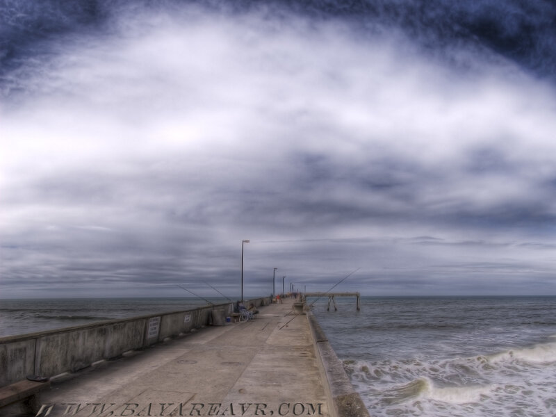 Pier under cloudy sky