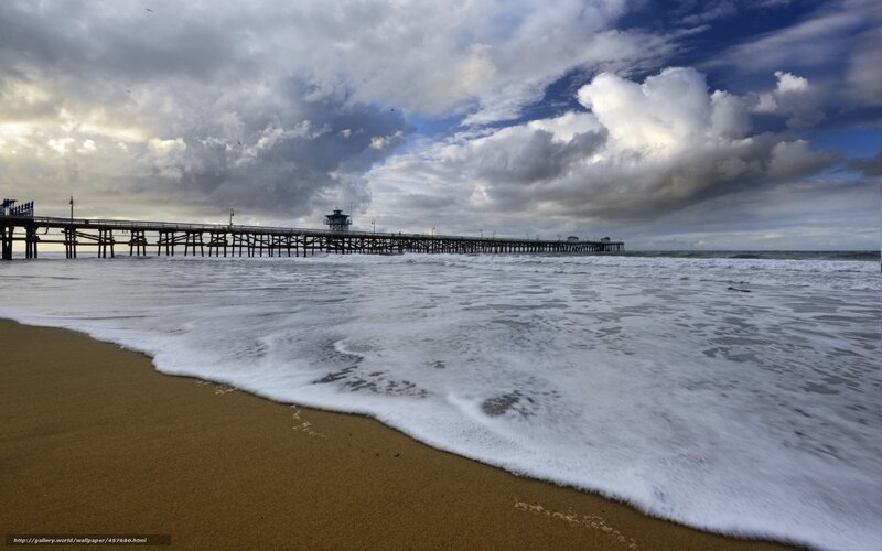 Pier under cloudy sky