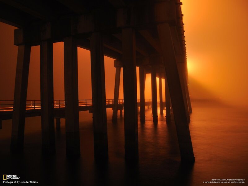 Pier under orange fog