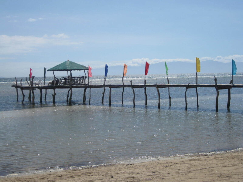 Pier with colorful flags at beach