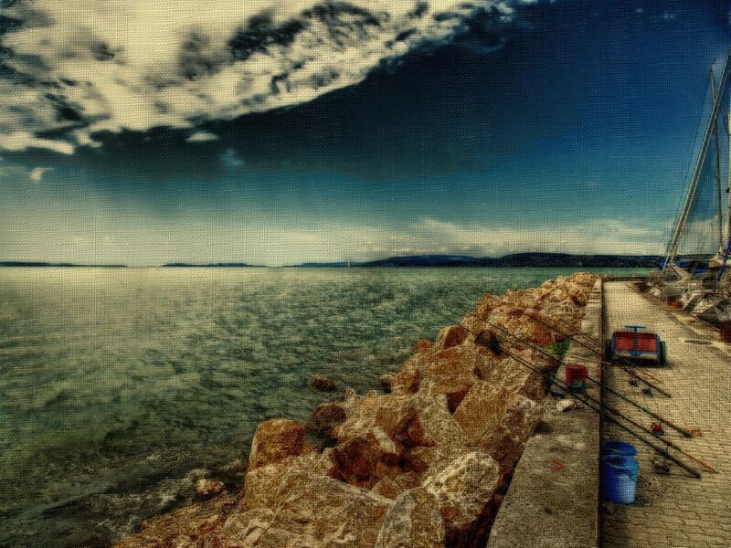 Pier with fishing rods at sea