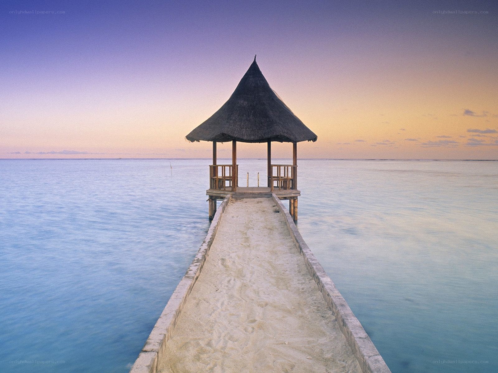 Pier with gazebo at sunset
