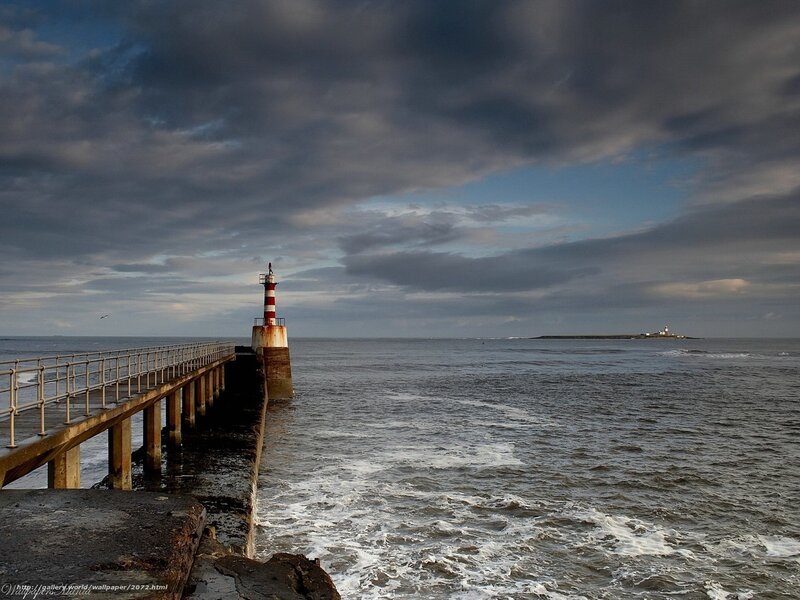 Pier with lighthouse at sea