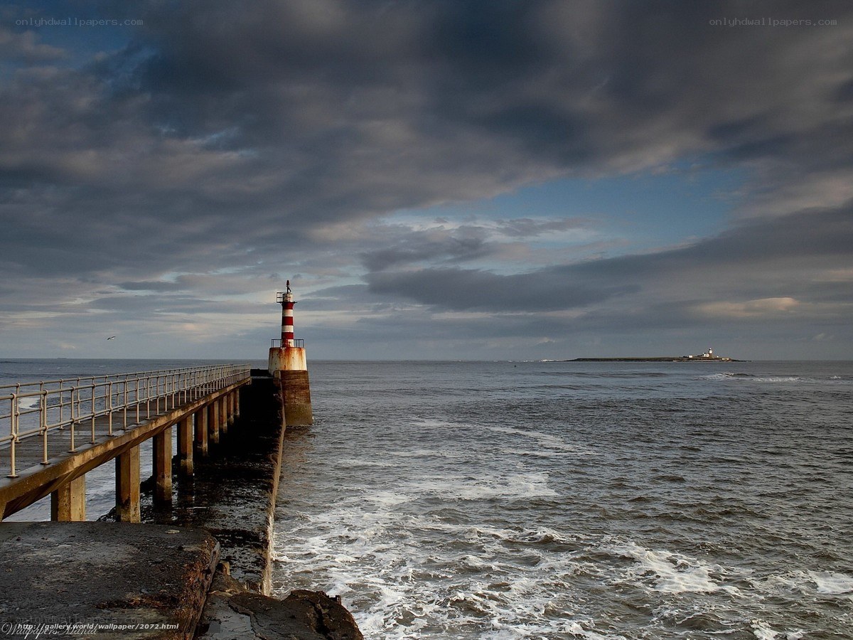 Pier with lighthouse at sea