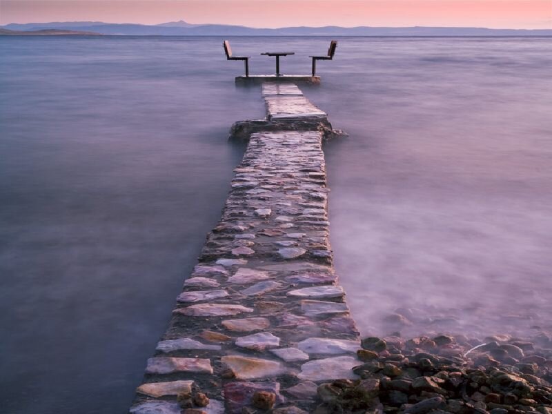 Pier with table at sunset