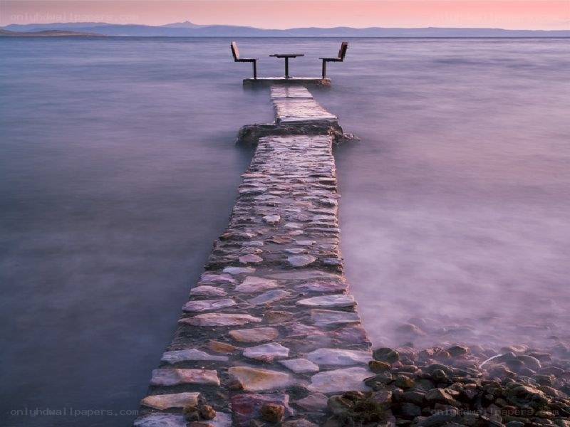 Pier with table at sunset