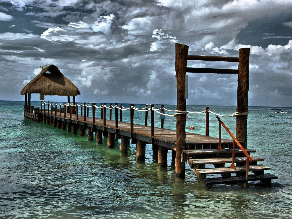 Pier with thatched hut at sea