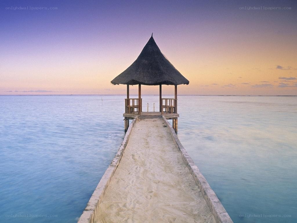Pier with Thatched Hut at Sunset