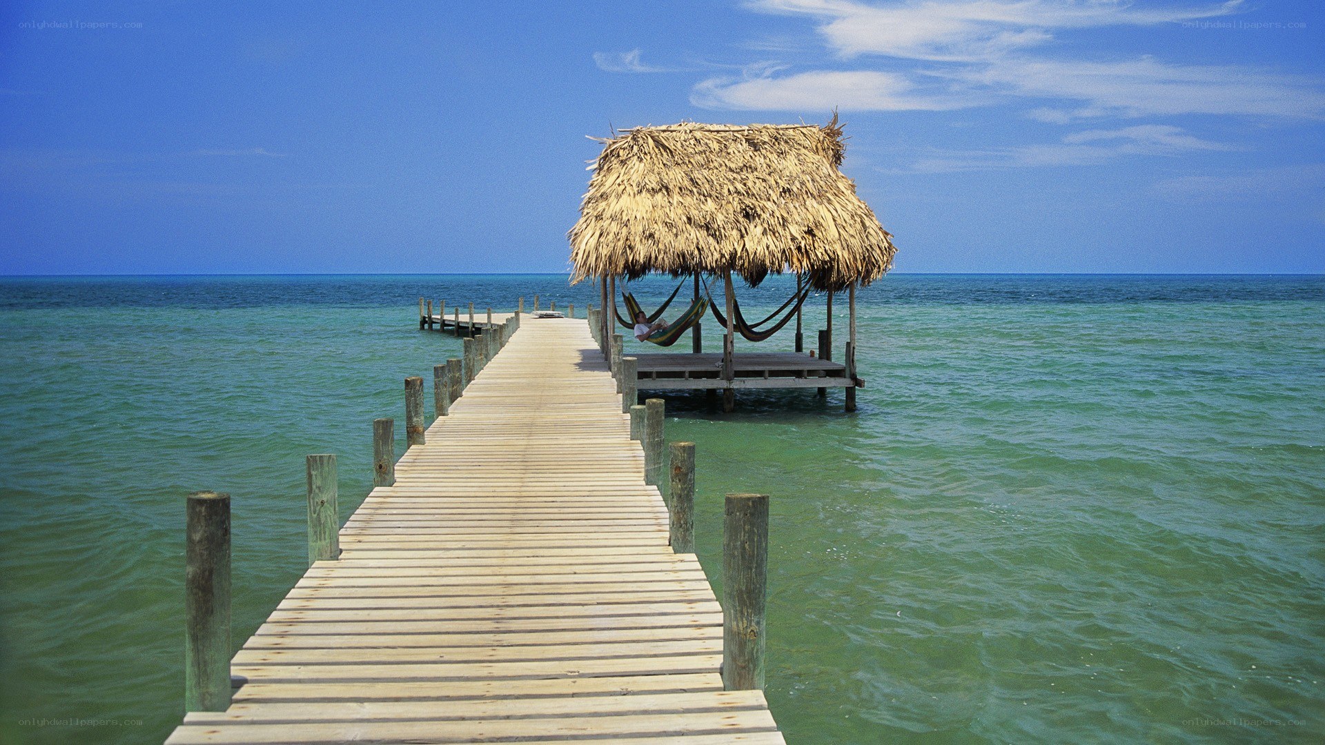 Pier with thatched hut over water