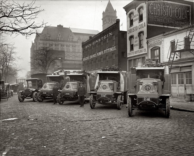 Piggly Wiggly trucks on cobblestone street