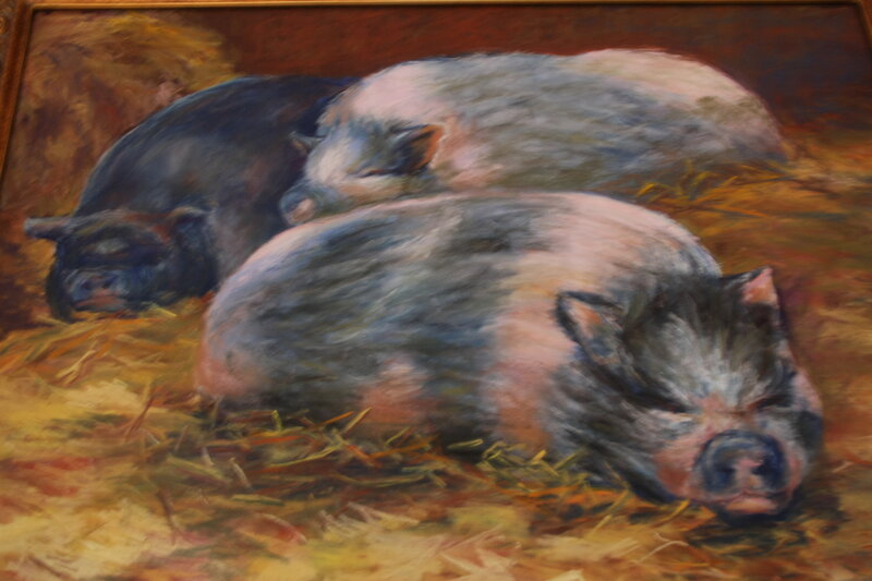 Pigs sleeping in hay