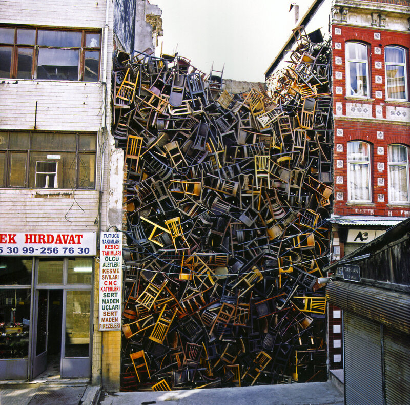 Pile of chairs in alley