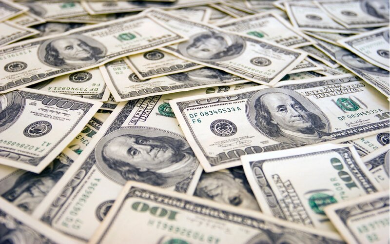 pile of hundred dollar bills