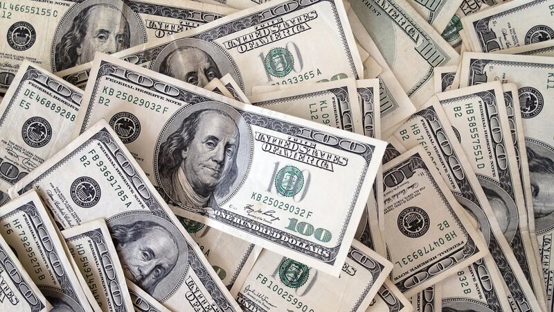 pile of hundred dollar bills