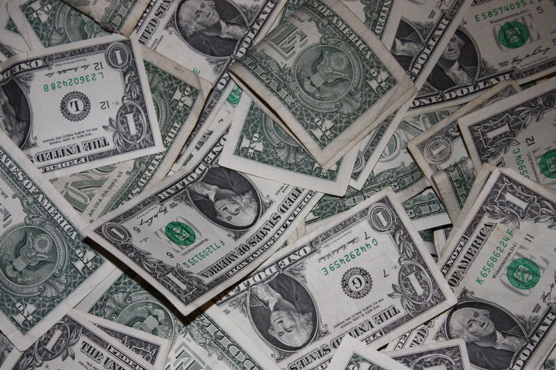 pile of one dollar bills